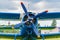 Blue painted legendary soviet aircraft biplane Antonov AN-2 closeup parked on the airfield against cloudy sky