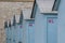 Blue painted plywood beach lockers along Lake Michigan