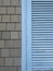 Blue painted window shutter with tiles