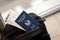 Blue Palestinian Authority passport with airline tickets on touristic backpack close up