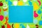 blue paper as copy space around it green part of the background with colorful paper fruits, creative diet design