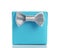 Blue paper giftbox with silver simple ribbon bow isolated