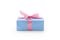 Blue paper present box with pink ribbon bow isolated on white background