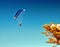 Blue paraglider flying