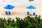 Blue parasol on the sand of Paciencia beach in the Rio Vermelho