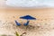 Blue parasol on the sand of Paciencia beach in the Rio Vermelho