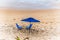 Blue parasol on the sand of Paciencia beach in the Rio Vermelho