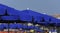 Blue parasols lined up at the beach, durable sun umbrellas providing shade and UV protection