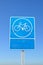 Blue parking bicycle sign on blue sky background.