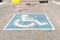 Blue parking sign on asphalt for disabled persons