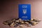 Blue passport of Ukraine on a many of coins.
