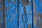 Blue peeling paint on wood