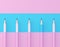 Blue pencil extract out from crowd of plenty identical pink fellows on pink pastel background. minimal creative concept. Leadershi