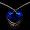Blue pendent in the form of heart, costume jewelry, close up