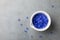 Blue petal of cornflowers in bowl for medical and cosmetic products. Flat lay style and top view