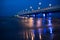 A blue pier illuminated on the shore of the Baltic Sea.