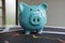 Blue piggy bank with stock graph, step up growing business to success and saving for retirement concept