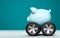 Blue Piggy bank with wheels on blue background