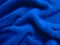 Blue pile fabric draped with pleats.