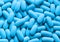 Blue pills seamless macro background.