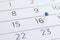 Blue pin on a 16th date on a calendar close-up. Important date. Place for text