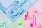 Blue, pink, mint color office stationery collection on soft pastel multicolor paper background, top view.