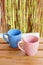 Blue and a pink mugs on a wooden table