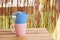 Blue and a pink mugs on a wooden table