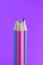 Blue and Pink Pencils on Purple Background