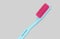 Blue and pink plastic toothbrush sideways isolated