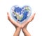 Blue planet in heart shape over woman human hands isolated