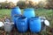 The blue plastic barrels for storage of chemicals . Stockpile of used blue plastic drums for storing water and other liquids