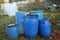 The blue plastic barrels for storage of chemicals . Stockpile of used blue plastic drums for storing water and other liquids