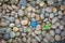 Blue plastic bottle cap on pebbles, Environmental pollution problem concept