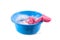 Blue plastic bowl with soap water and foam and a pink cleaning c