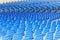 Blue plastic chairs arranged in rows around the circle in the hall for business presentations