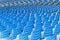 Blue plastic chairs arranged in rows around the circle in the hall for business presentations