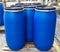 Blue plastic drums on wooden pallet