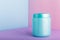 Blue plastic jar with mock up for cosmetic products on color pink background with Copy space. Cosmetic package for hair mask,