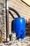 Blue plastic rain water barrel. watering the garden. Water saving. Water supply for dry summer. Rainwater drainage