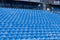 Blue plastic seats on the open tribune of the sports stadium. A place for the press