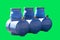 Blue plastic septic tanks isolated on a green background. Barrels for sewage