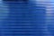 Blue plastic striped polycarbonate surface in the sun