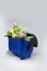 Blue plastic toy garbage can bin container with wild flowers bouque
