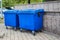 Blue plastic trash recycling containers. Blue containers for collecting garbage on the dustbin