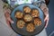 Blue plate of easy to prepare and healthy, home made outmeal cookies â€“ made by a little child