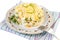 On a blue plate, a freshly prepared salad for the festive table with crab sticks, sweet corn, fresh cucumber, cheese, dill.