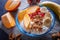 A blue plate with greek yogurt, granola, persimmon, banana, pomegranate on black background