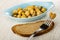 Blue plate with marinated champignons, mushroom on fork. slice of bread on table