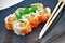 Blue Plate With Sushi Appetizer and Chopsticks